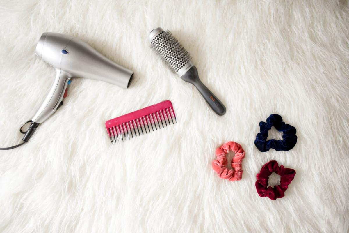 grey hair blower near pink hair combs and scrunchies 1