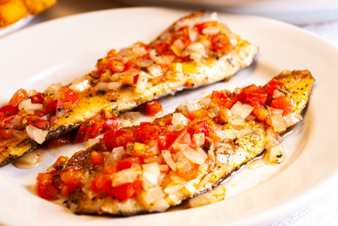 grilled trout tomato sauce with onion pepper background carrot cabbage pickle salad