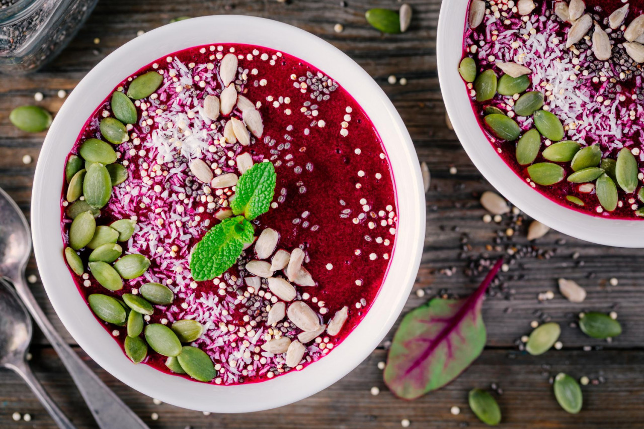 healthy vegan breakfast superfood beet smoothie bowl with chia seeds coconut pumpkin seeds quinoa sunflower seeds mint