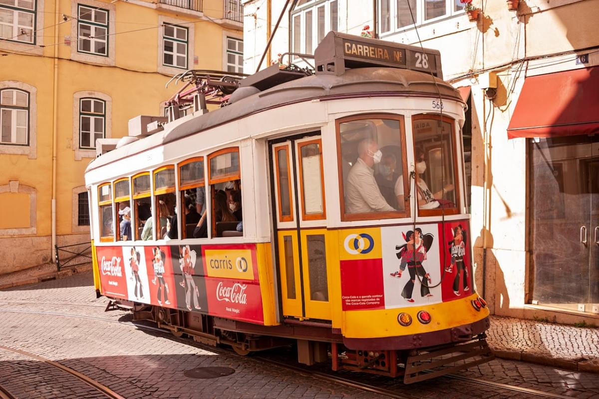 historic tram line 28 in lisbon with a coca cola advertisement