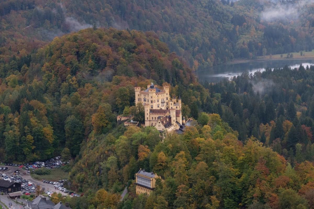 hohenschwangau castle on trees covered mountain