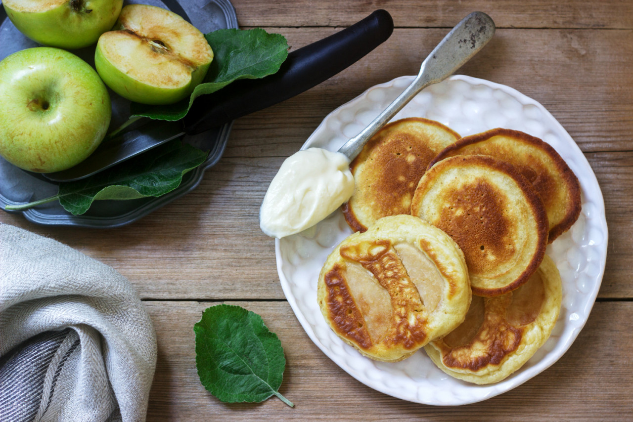 homemade apple fritters with sour cream coffee green apples wood