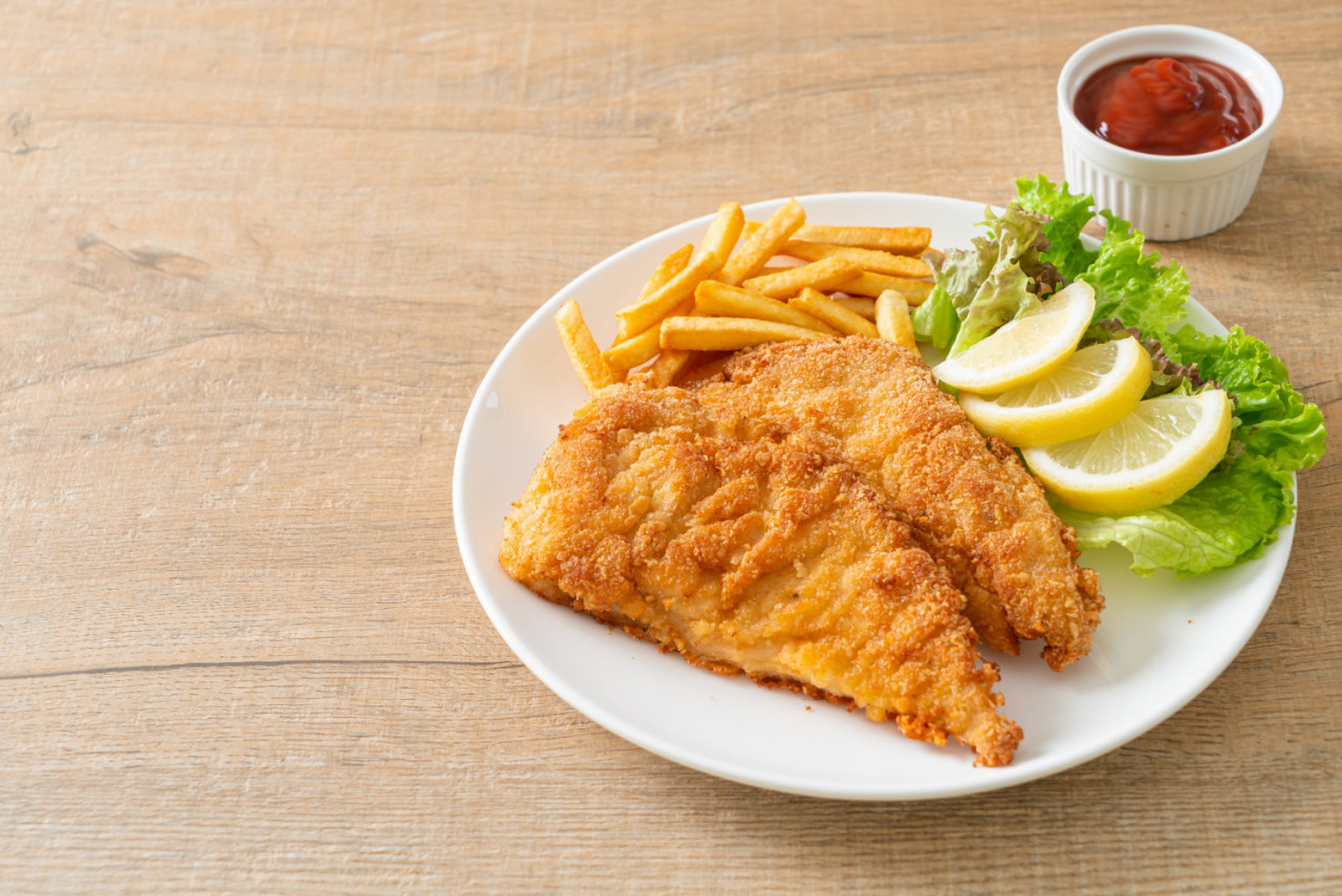 homemade breaded weiner schnitzel with potato chips fried chicken with french fries european food style