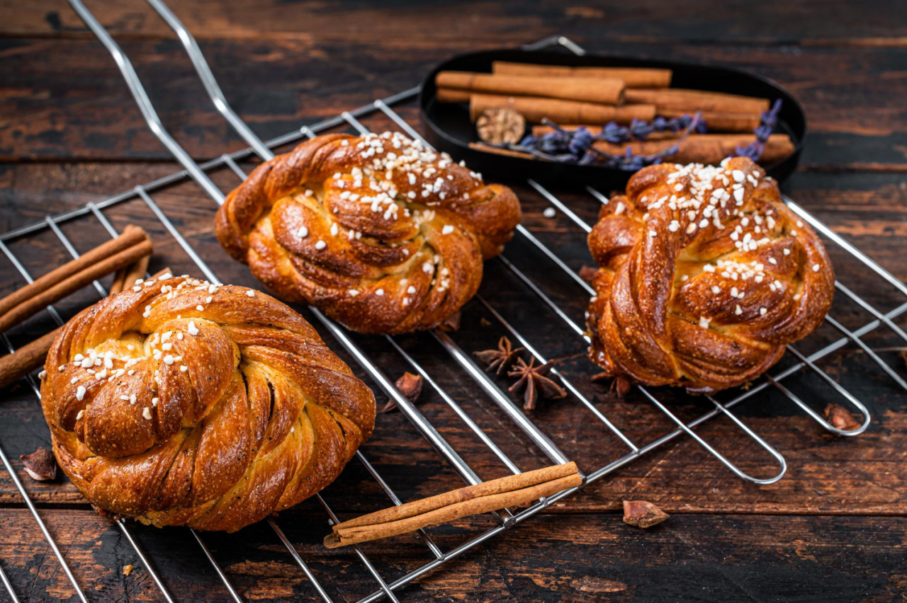 homemade fresh baked cinnamon buns rolls swedish kanelbullar dark wooden background top view