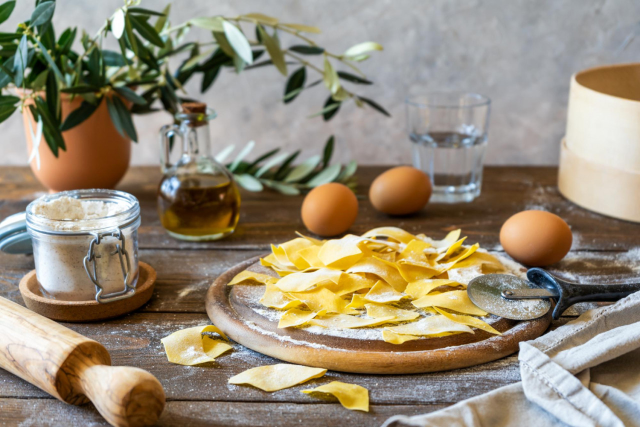 homemade pasta maltagliati cutting board with ingredients