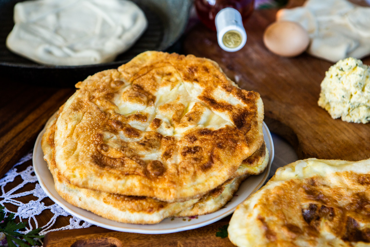 image with hands lady cooking traditional romanian fried pies with cheese