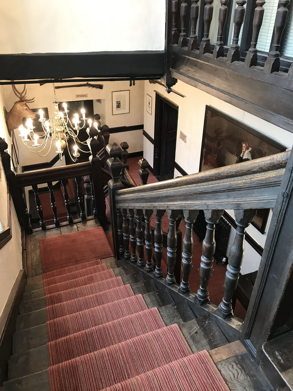internalviewofoakstaircasewiththetalbothotel