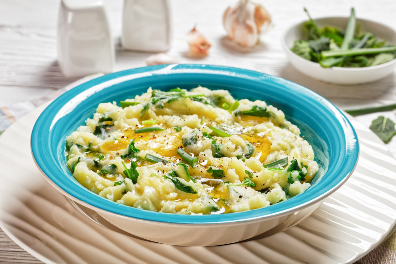 irish colcannon traditional potato mash with kale garlic melted butter spring onion served blue bowl white counter plate white wooden background top view close up