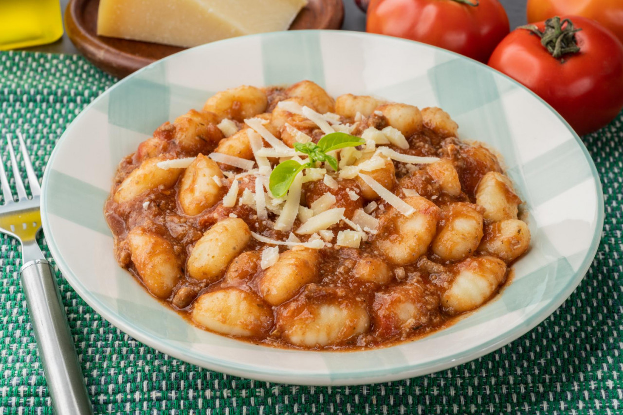 italian pasta gnocchi plate with bolognese sauce basil parmesan cheese