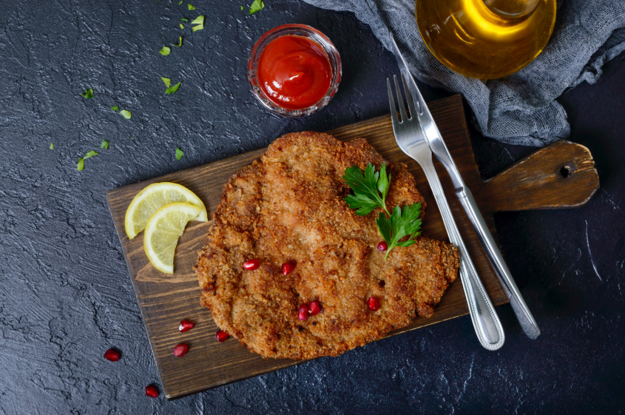 large viennese schnitzel black surface meat dish top view flat lay