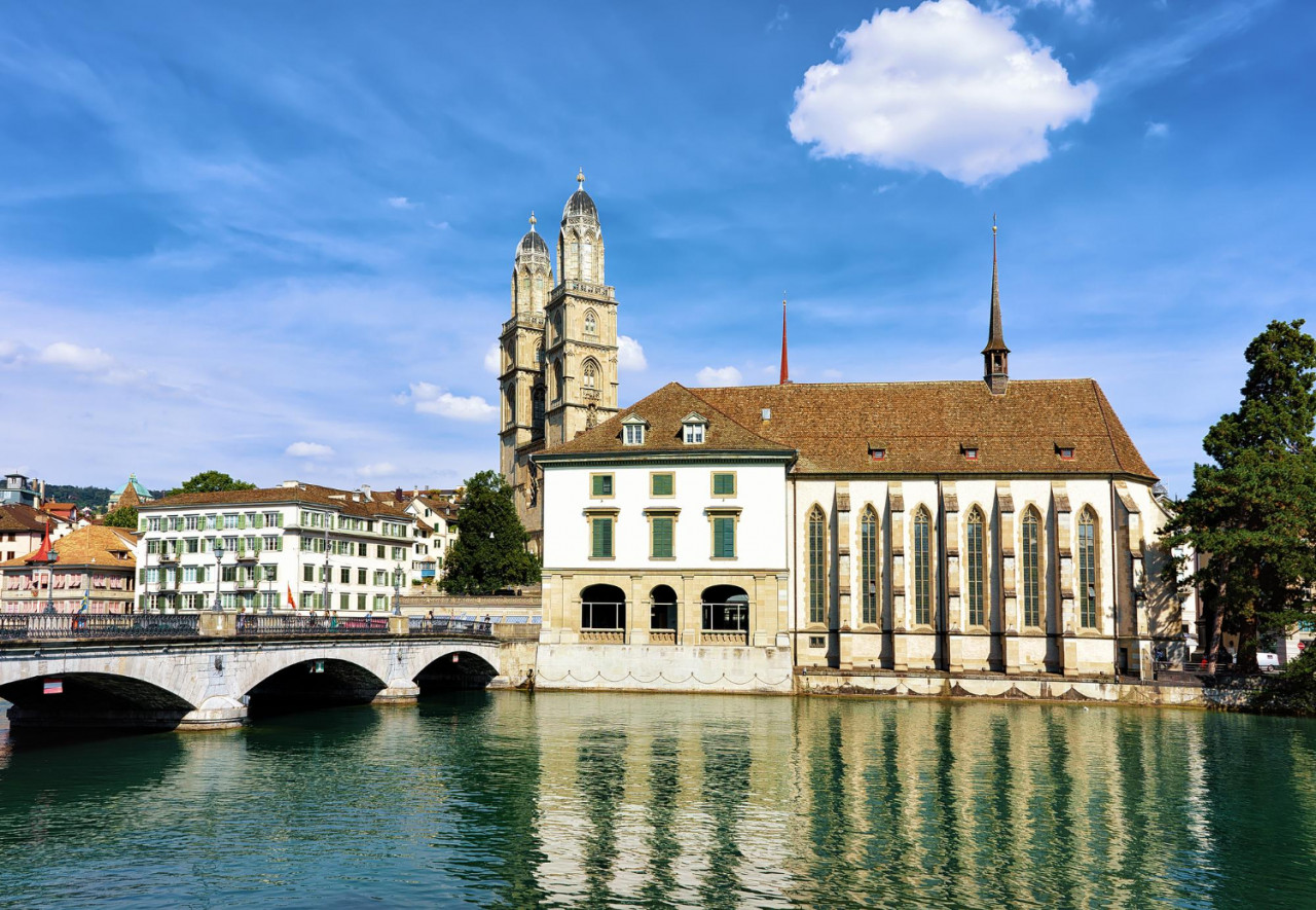 limmat river quay with grossmunster church wasserkirche zurich switzerland people background