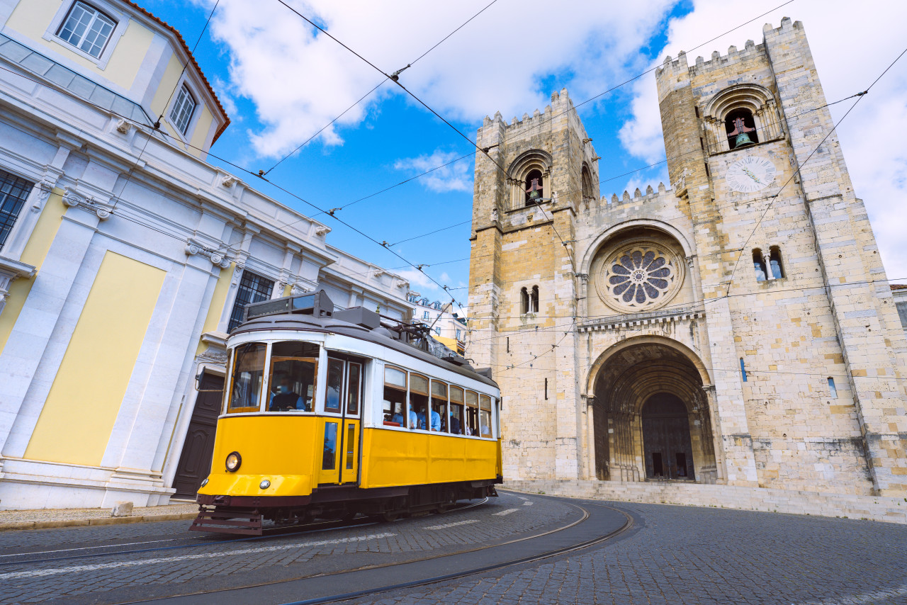 lisbon city old town famous yellow tram 28 front santa maria cathedral