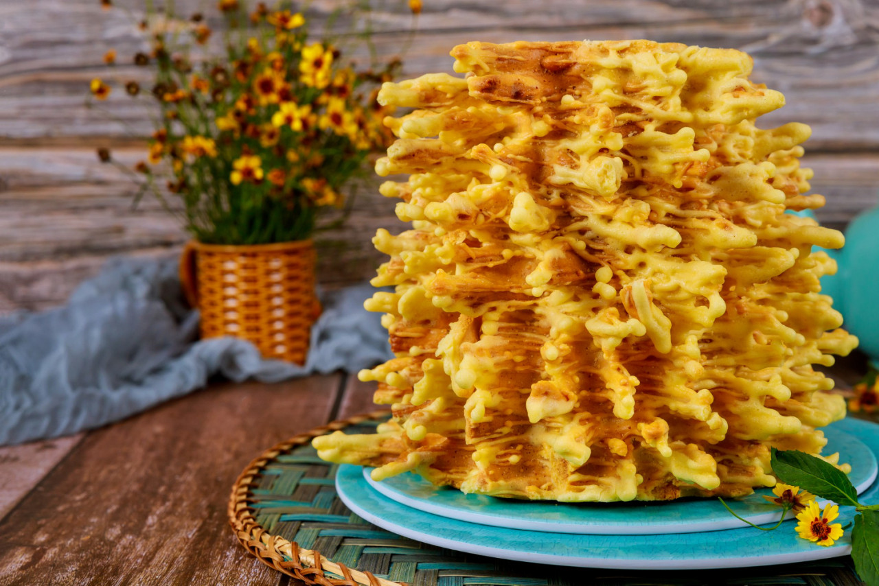 lithuanian traditional layered cake with flowers wooden surface