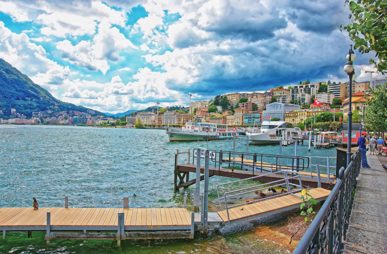 lugano switzerland august 26 2013 ship landing stage promenade resort lugano lake lugano alps mountains ticino canton switzerland people background