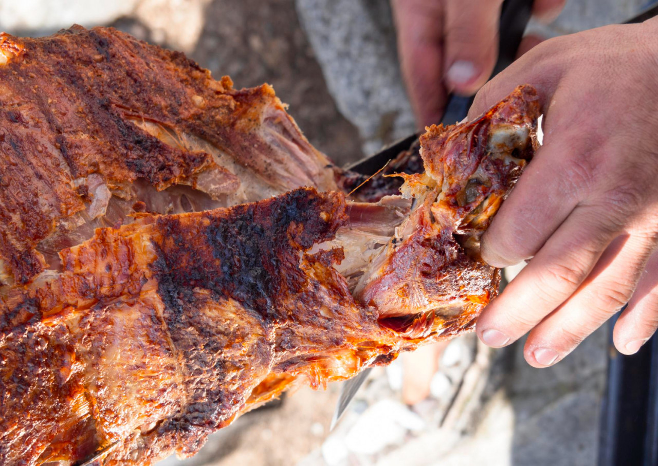 man is chopping meat with axeknife traditional food easter greece