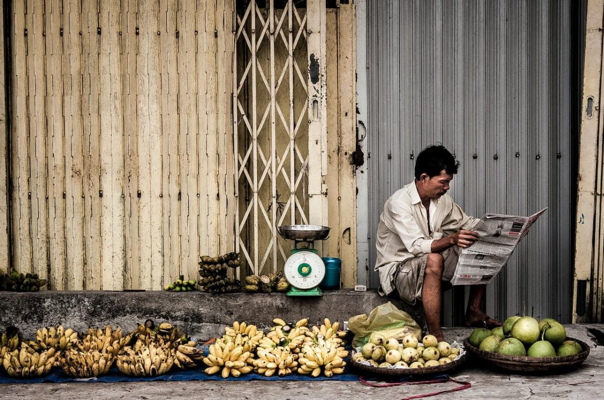 man sitting near fruits 1