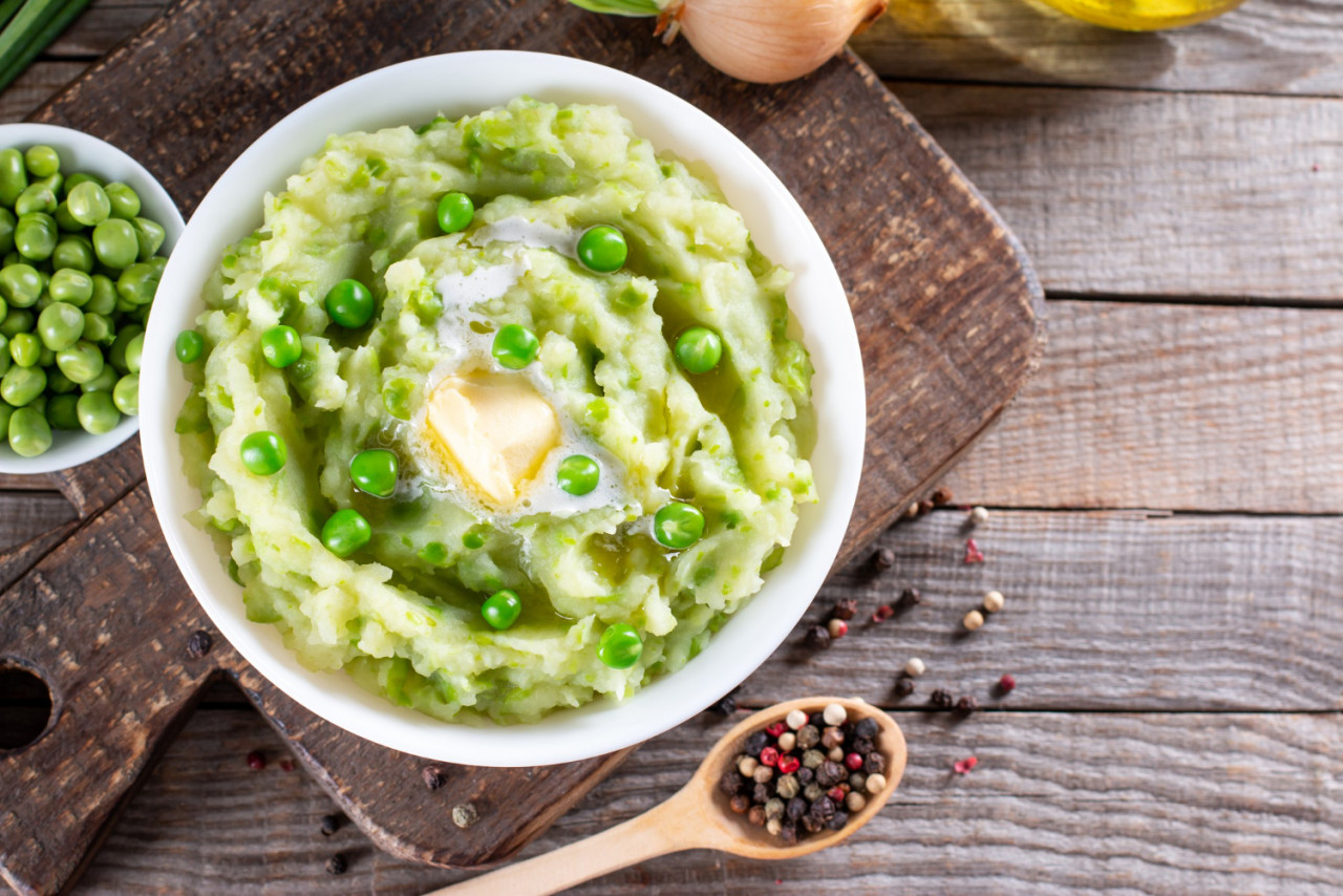 mashed potatoes with green peas spices ceramic bowl wooden table with free space healthy vegetarian food