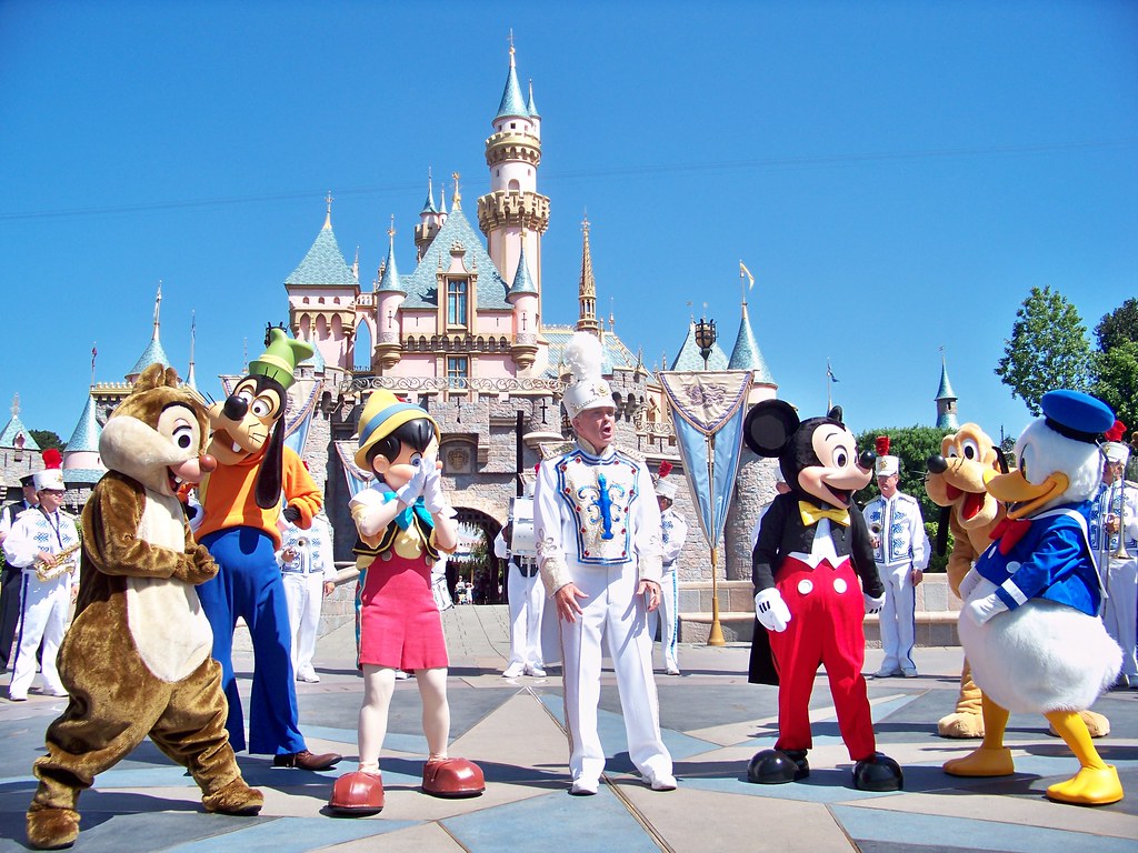 mickey friends perform with the disneyland band in front of sleeping beauty castle