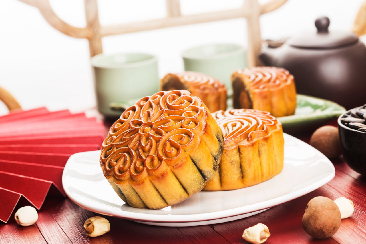 midautumn festival concept traditional mooncakes table with teacup