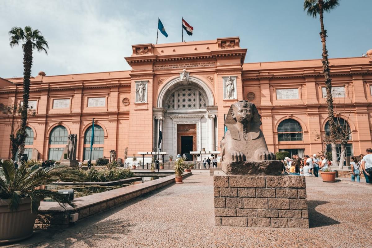 old palace with bas reliefs and arched entrance on well groomed square