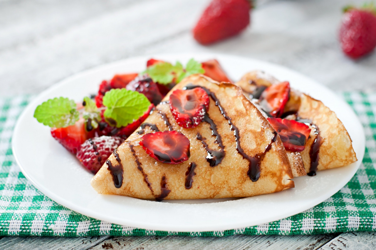 pancakes with strawberries chocolate decorated with mint leaf