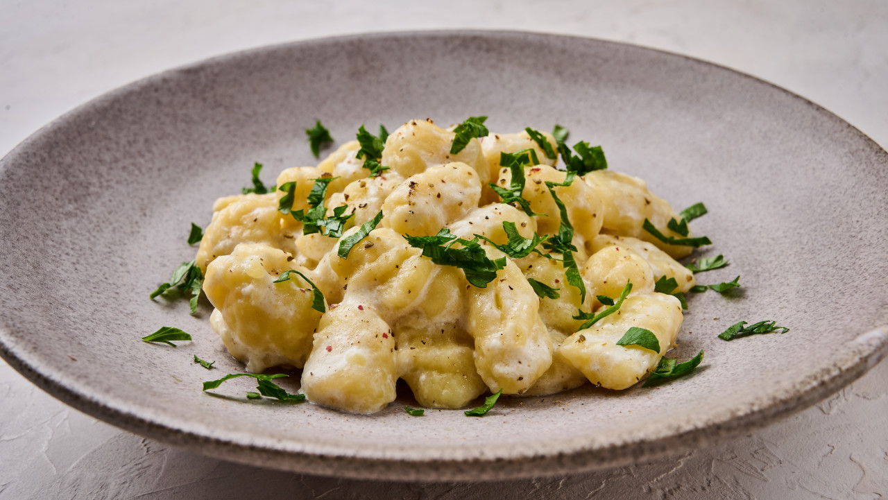 panoramic view gnocchi prepared with potato whole grain flour dough with cream sauce parsley