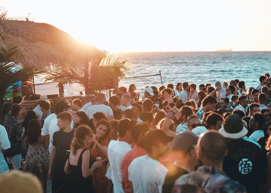 people on the beach during sunset