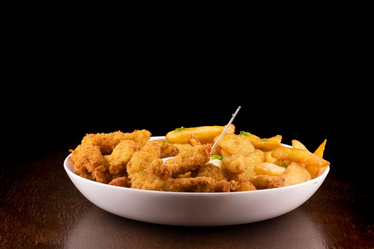 portion fish chips wooden table black background