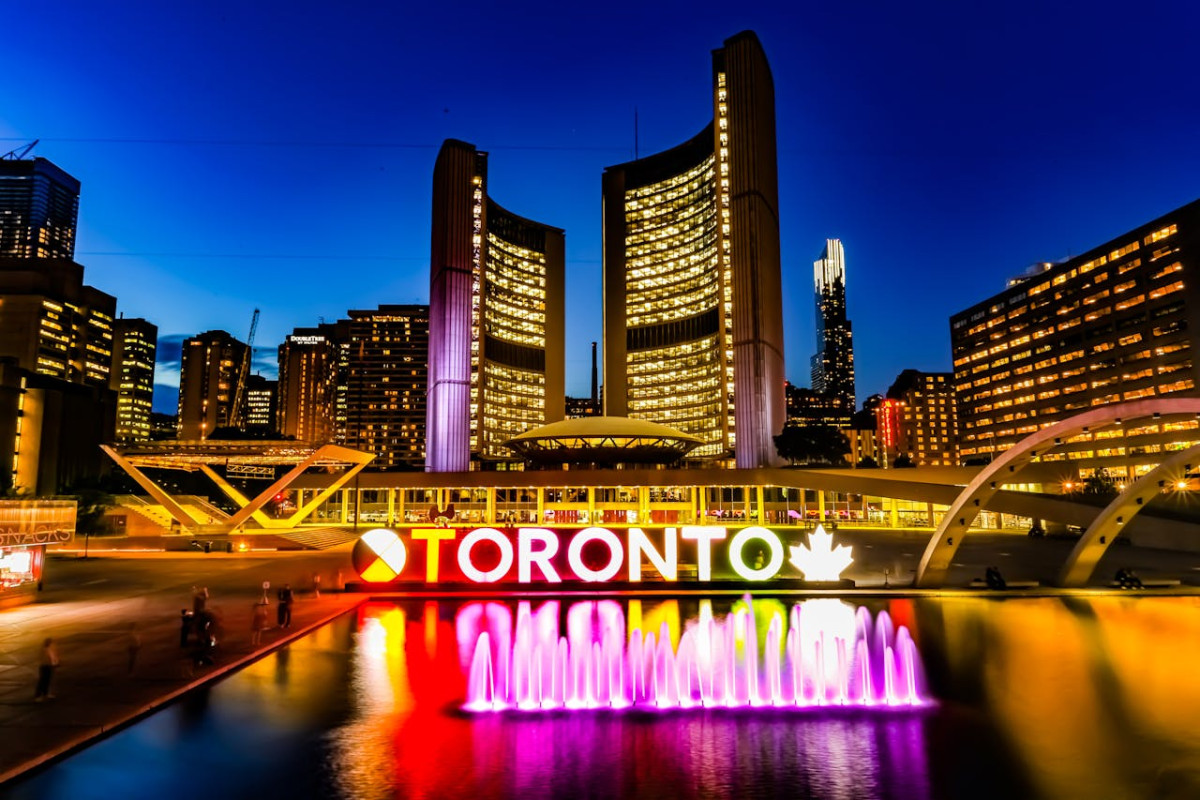 powered on toronto neon sign near water fountain