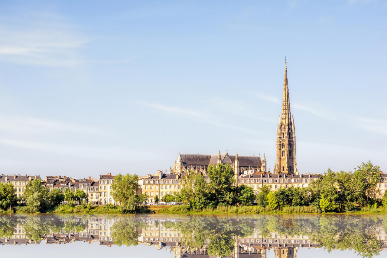 riverside view garonne river with saint michel cathedral bordeaux city france