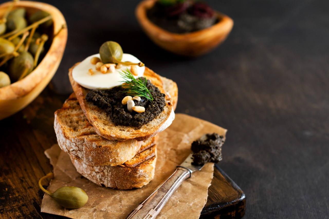 sandwich with slice mozzarella cheese tapenade caper dark rustic table background traditional provence dish selective focus