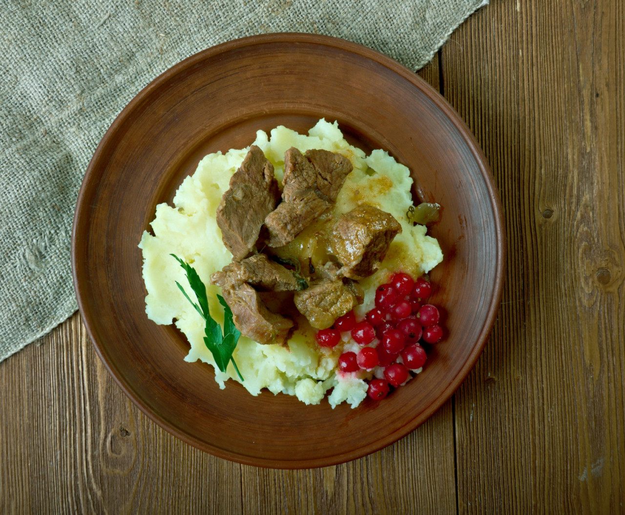 sauteed reindeer venison steak served with mashed potatoes lingonberry