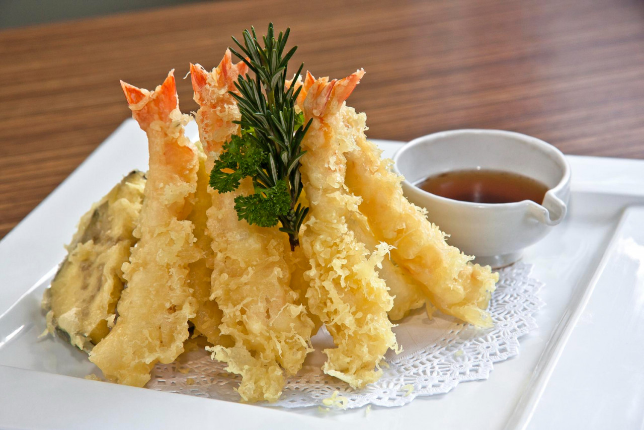 shrimp vegetable tempura with soy sauce white square plate wooden background close up