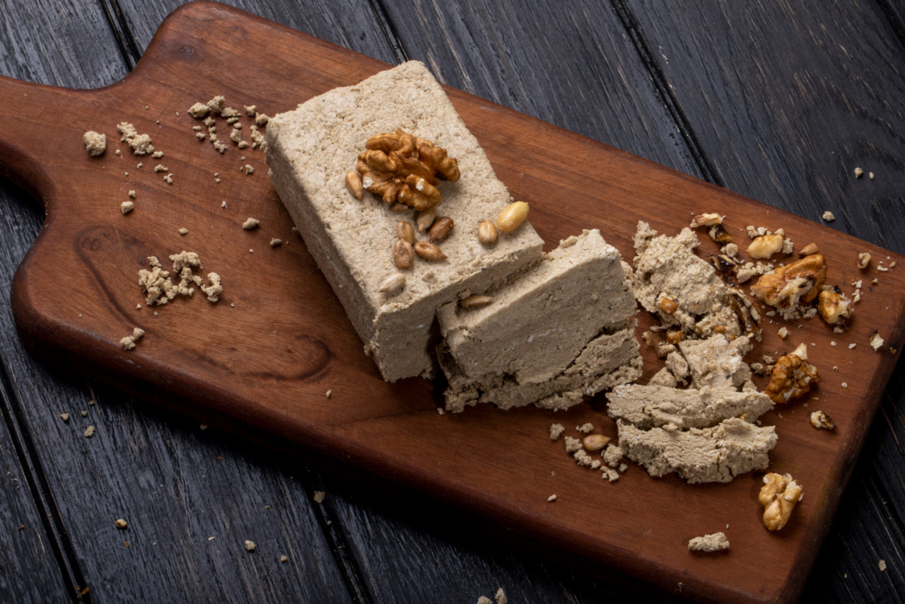 side view halva with sunflower seeds walnuts wooden board 1