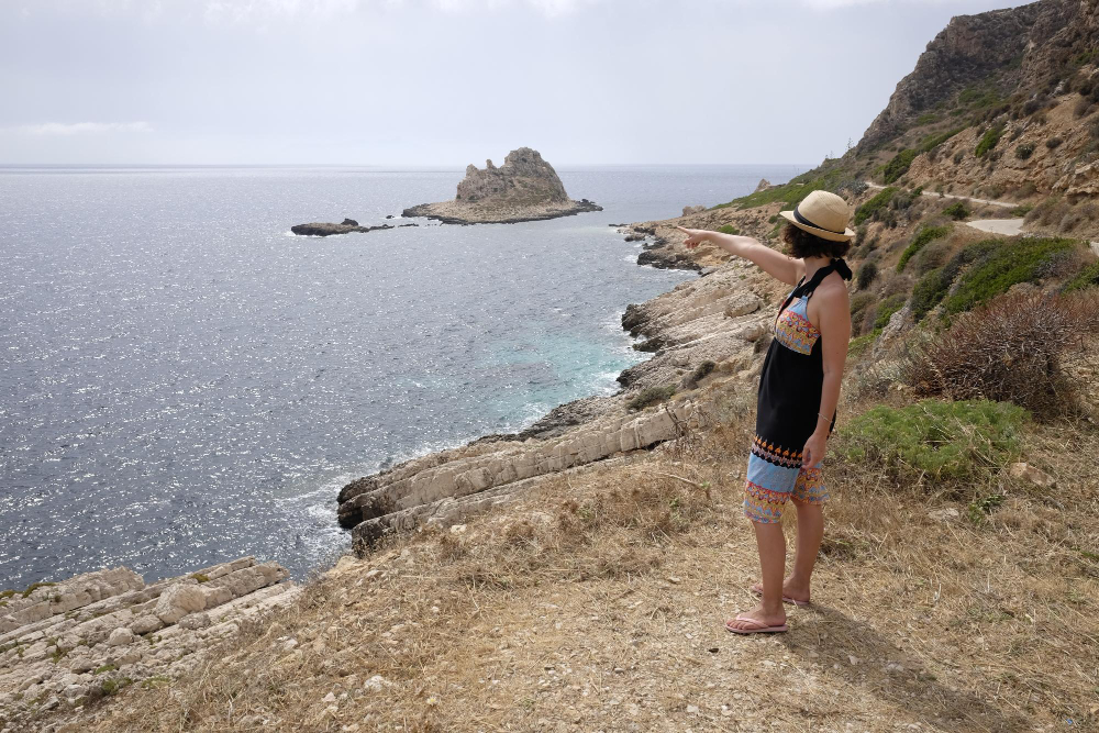 side view woman standing cliff by sea levanzo island