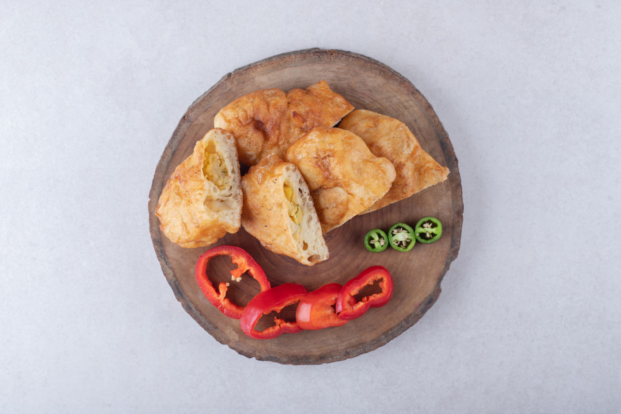 sliced pirozhki peppers board marble table