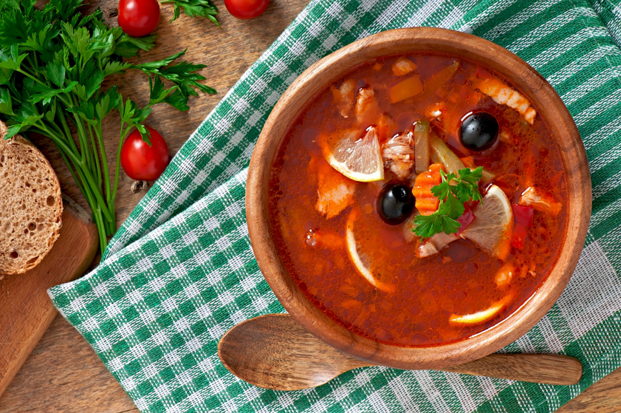 soup solyanka russian with meat olives gherkins wooden bowl