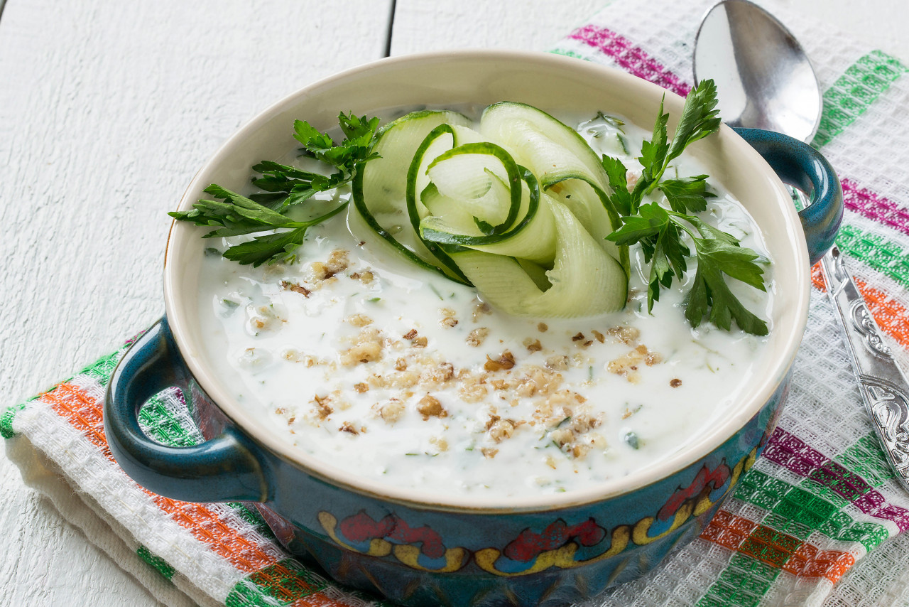 spring bulgarian cold soup tarator with yogurt cucumber garlic dill walnuts glass beakers white wooden table