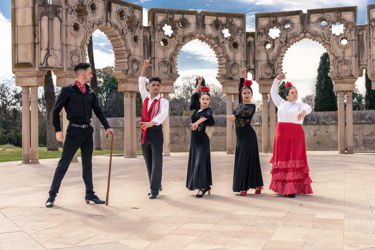 square front some ornamental arches flamenco master instructs his apprentices flamenco