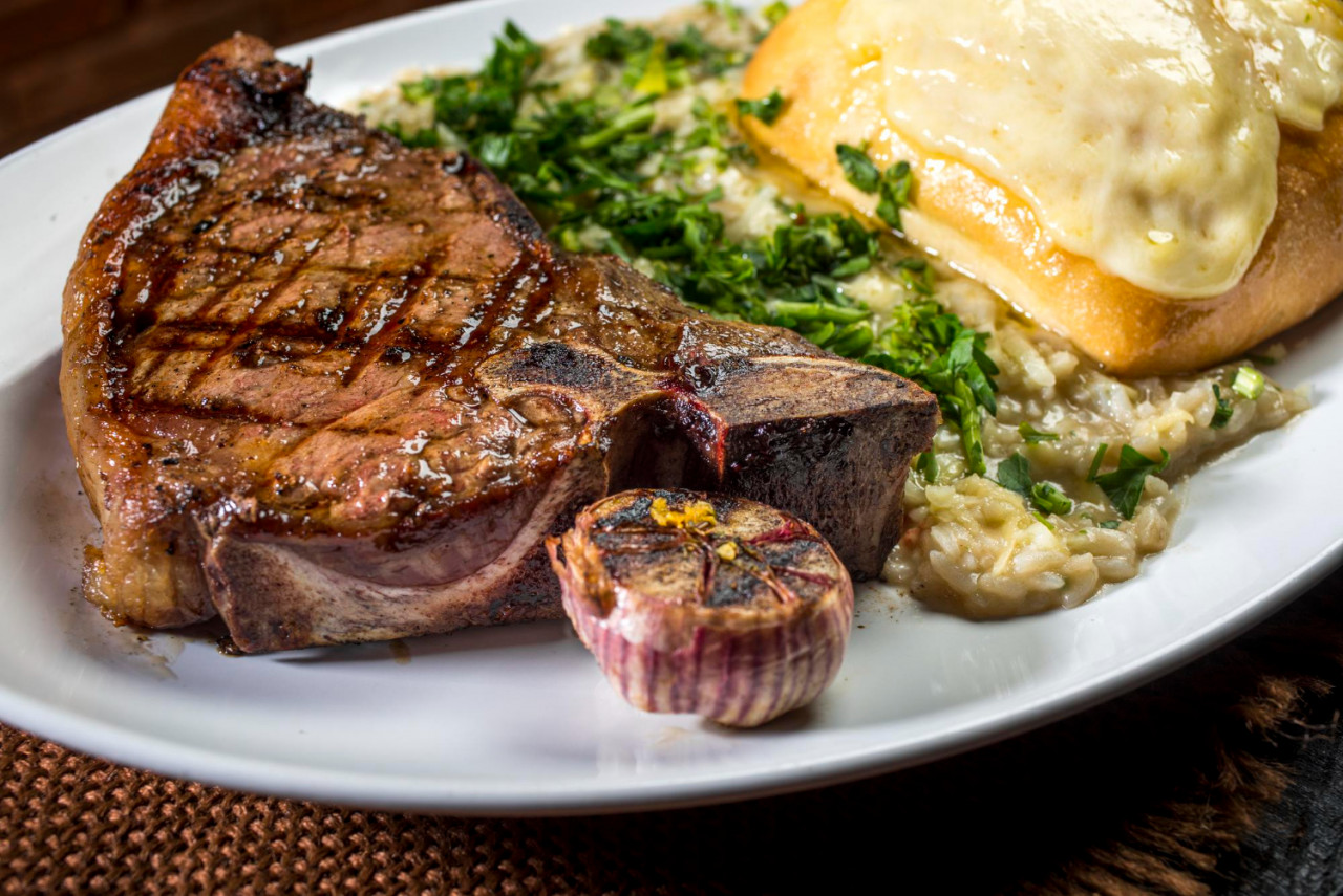 steak beef cut with risotto baked garlic crostinni with melted cheese