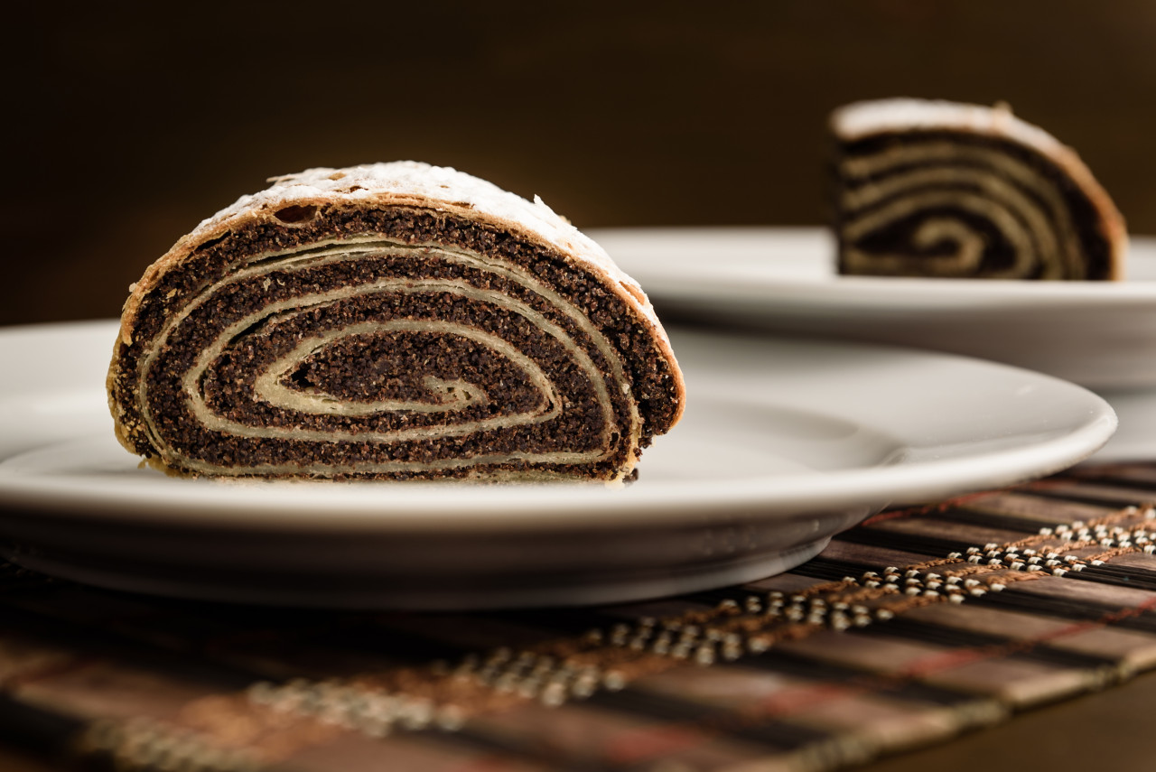 strudel with poppy seeds ceramic white plate wooden background