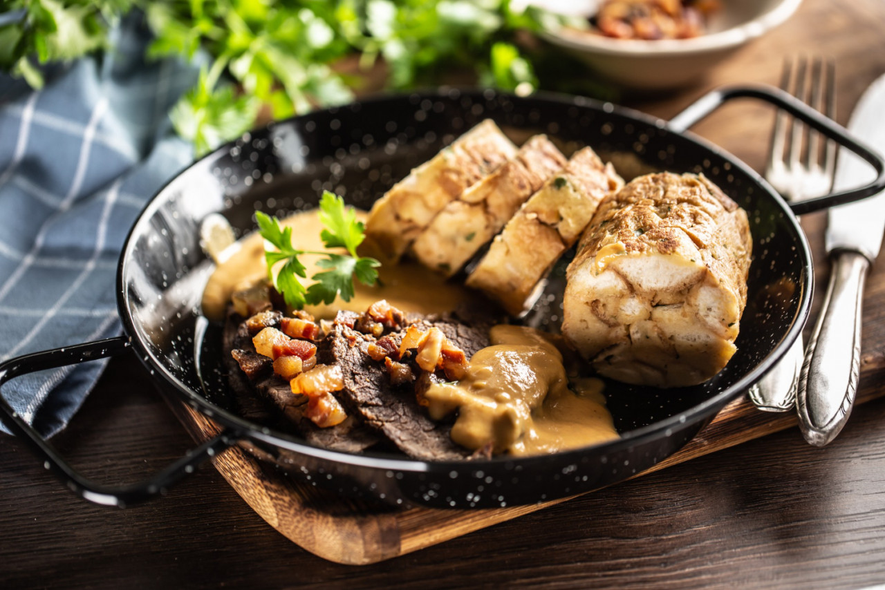 svieckova food with dumplings sauce and beef served in a dark plate typical czech food