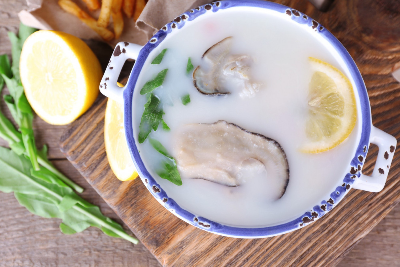 tasty soup with oysters wooden table