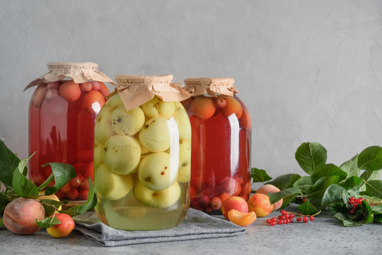 three canned apple cherry compote large glass jars gray table