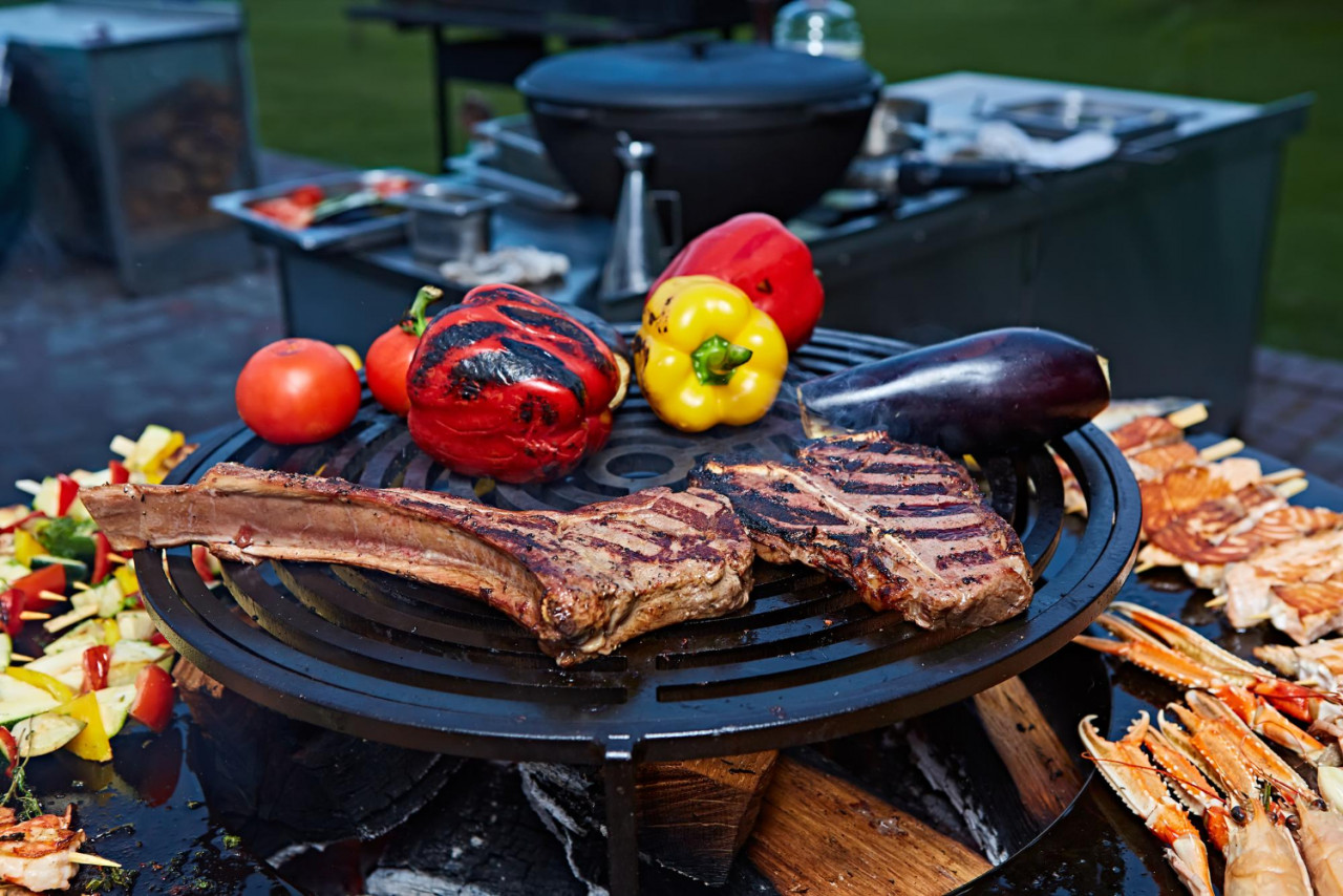 tomahawk rib beef steak and tbone on hot black grill
