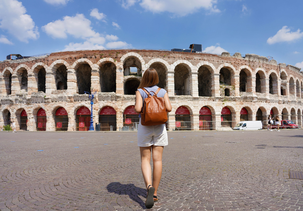 tourism verona back view tourist woman walks towards verona arena italy