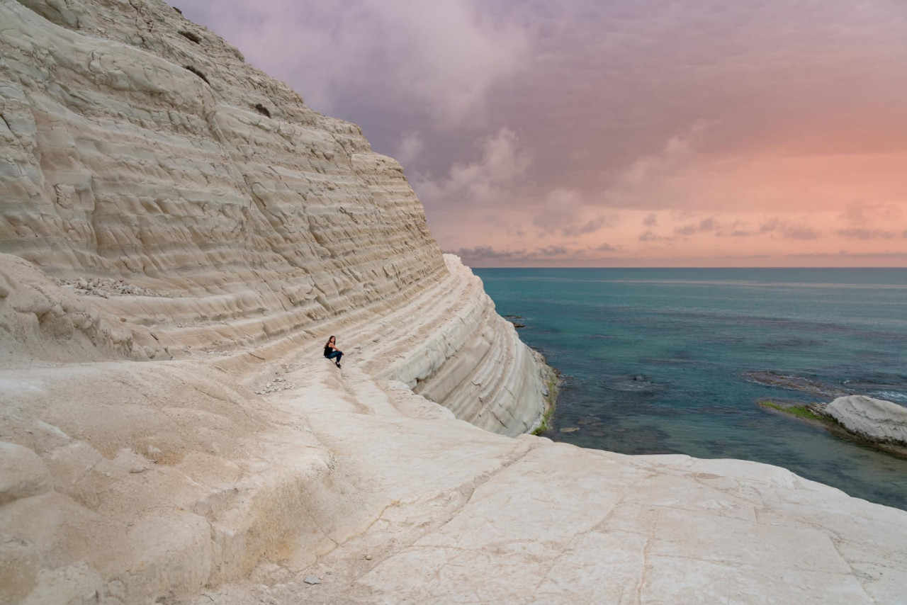tourist admiring white cliffs scala dei turchi agrigento sicily italy stairs turks