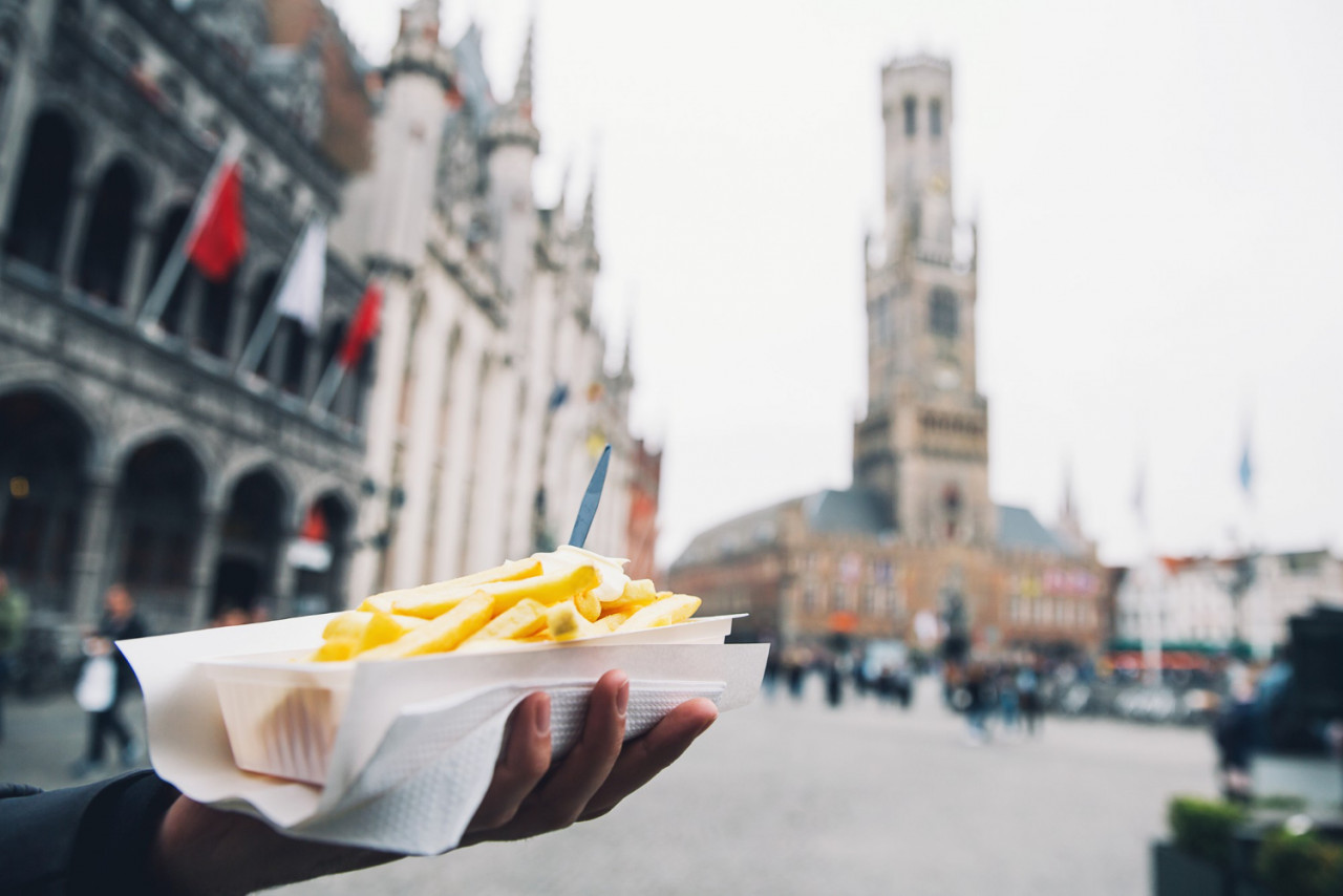 tourist holds popular street junk food french fries holland amsterdam netherlands