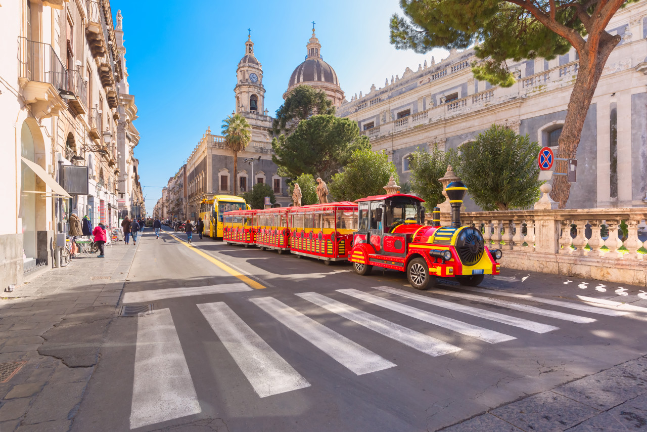 tourist train near cathedral santa agatha sunny morning sicily