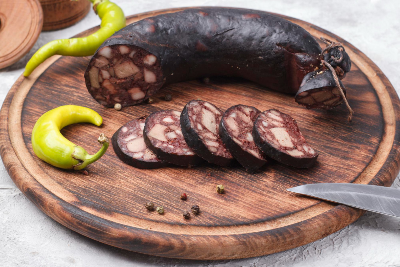 traditional blood sausage cut into wedges wooden board
